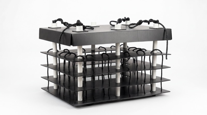 The Dock Habitat reef structure — stacked black HDPE trays on white posts, rigged with rope